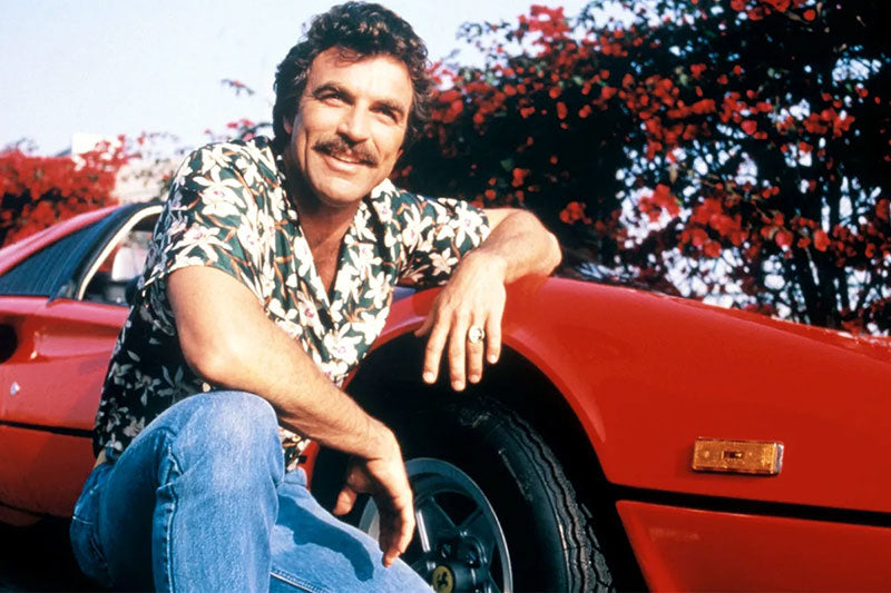 Tom Selleck as Magnum PI, wearing a famous Hawaiian shirt