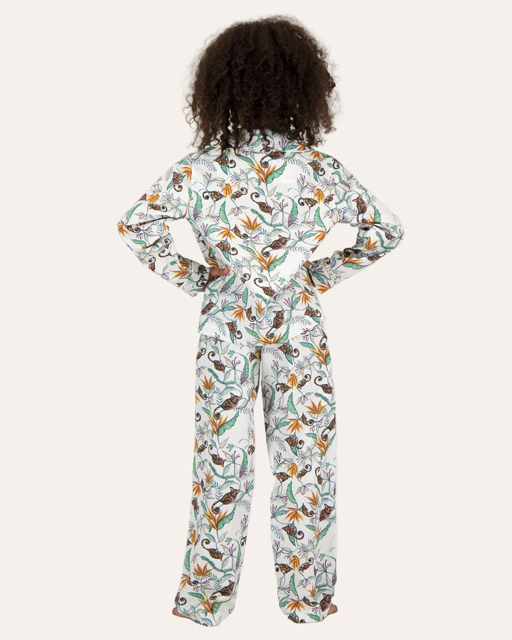 A girl wearing Long Pyjamas with Nag Apies on White Pattern - Woodstock Laundry