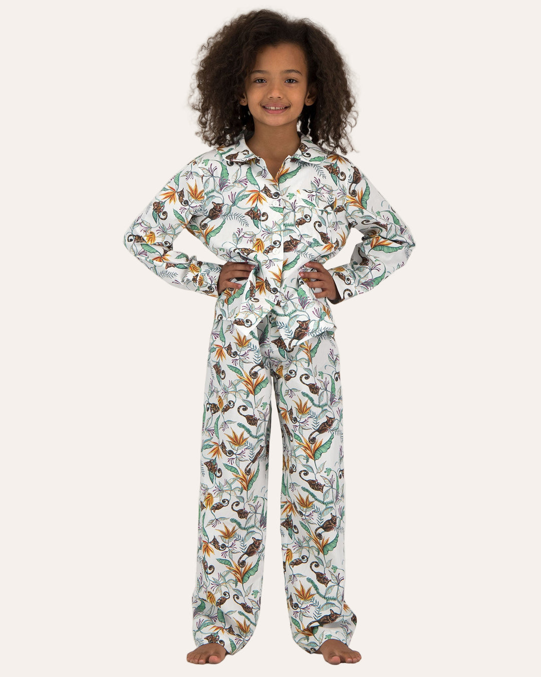 A girl wearing Long Pyjamas with Nag Apies on White Pattern - Woodstock Laundry