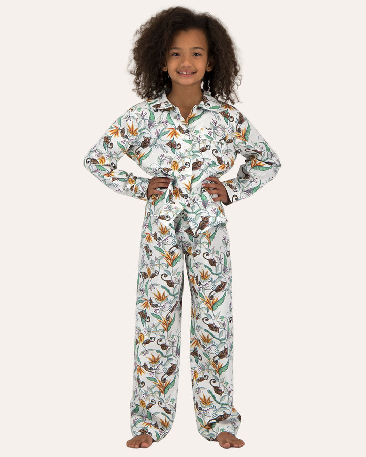 A girl wearing Long Pyjamas with Nag Apies on White Pattern - Woodstock Laundry