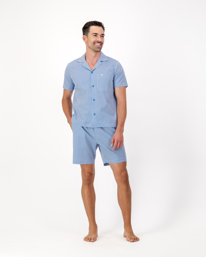 Man wearing a blue and white pin stripe organic cotton pyjamas