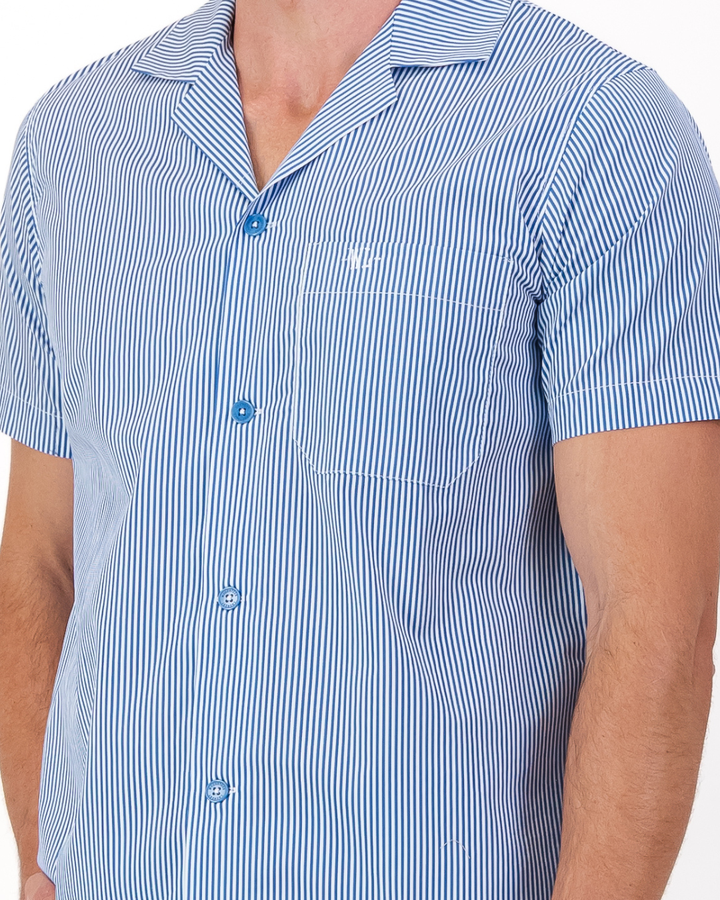 Signature Woodstock Laundry embroidery on the chest pocket of a men’s blue and white striped organic cotton pyjama shirt
