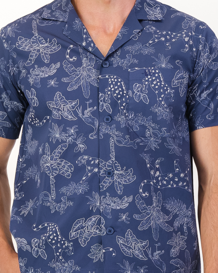 Close-up of signature Woodstock Laundry embroidered chest pocket and organic cotton tropical leopard print fabric detail