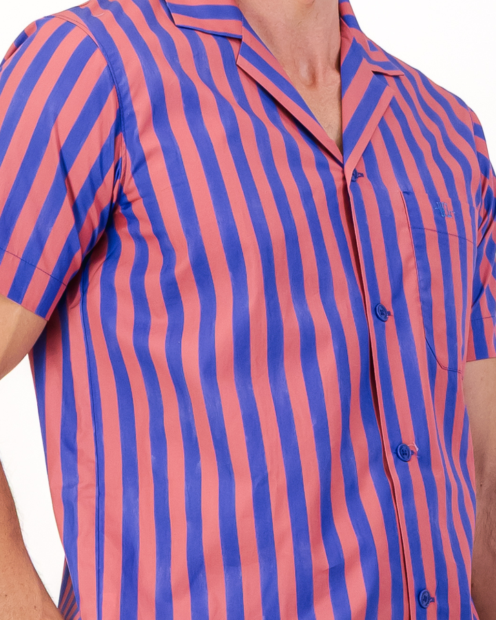 Close-up of signature Woodstock Laundry embroidered chest pocket and organic cotton red and blue stripe fabric detail 