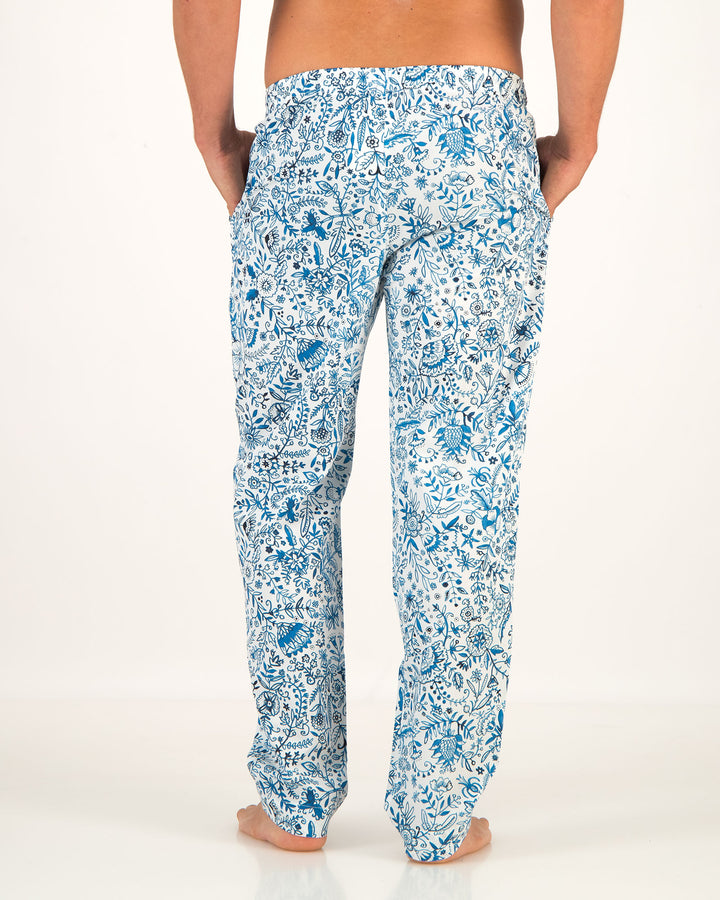 Blue floral patterned pants worn by a person on a white background