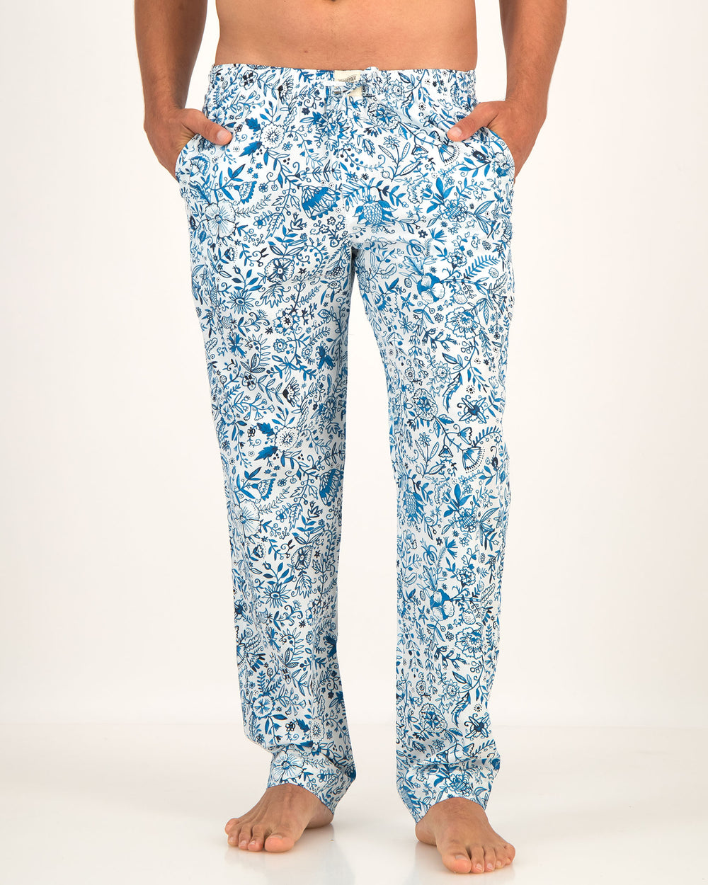 Blue floral patterned pants worn by a person on a white background