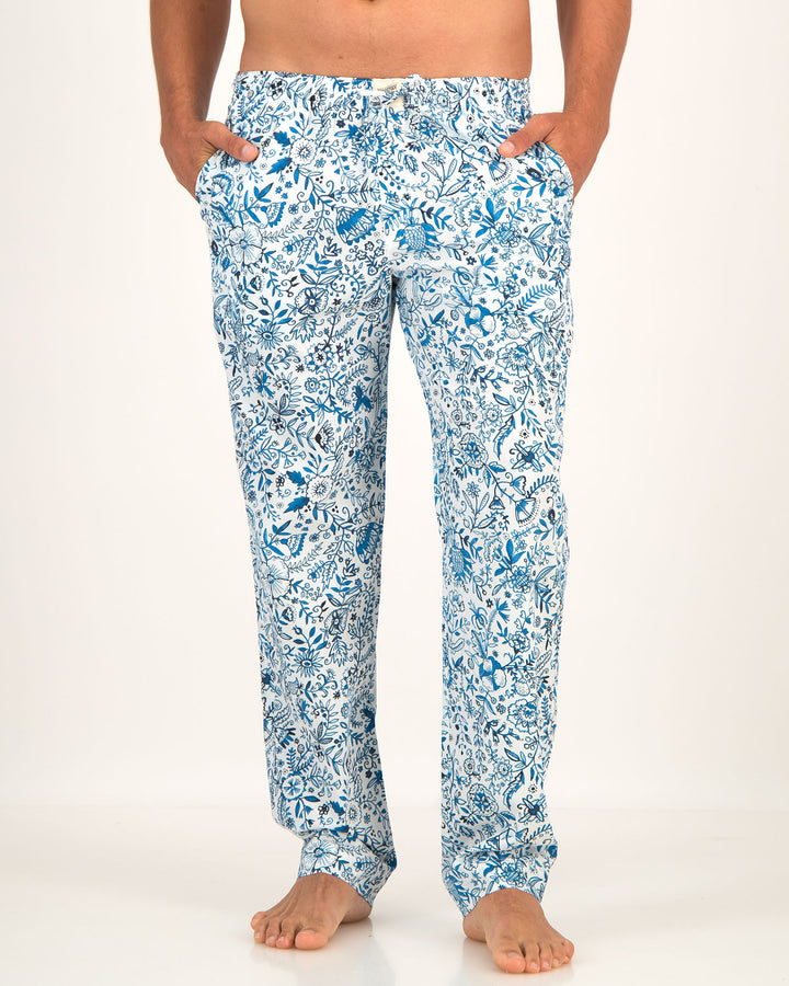 Blue floral patterned pants worn by a person on a white background