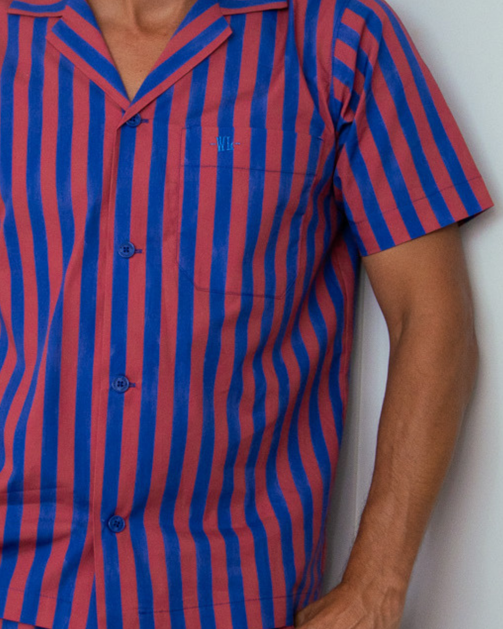 Signature Woodstock Laundry embroidery on a red and blue striped organic cotton pyjama shirt pocket
