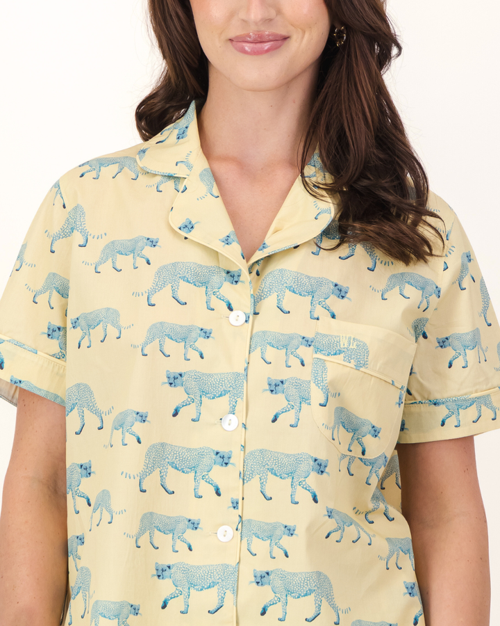 Woman wearing a yellow pajama set with blue cheetah's