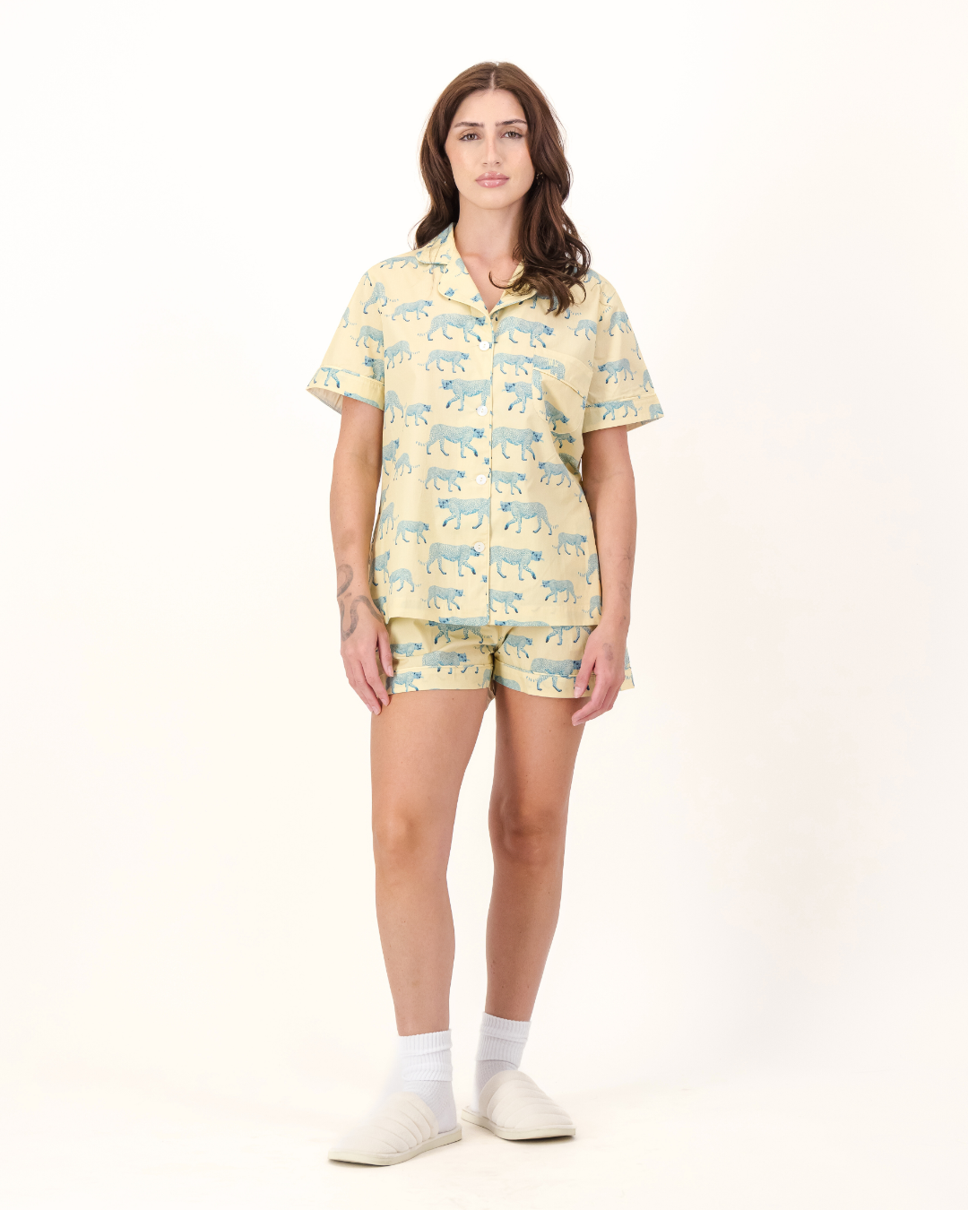 Woman wearing a yellow pajama set with blue cheetah's